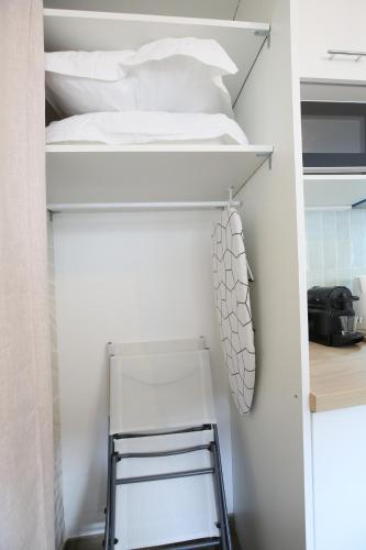 a bedroom with a bunk bed and a chair at expat renting - Le Dolce Vita - Netflix in Toulouse