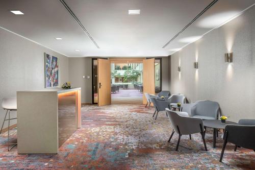 a waiting room with chairs and tables in a building at Hilton Prague Hotel in Prague