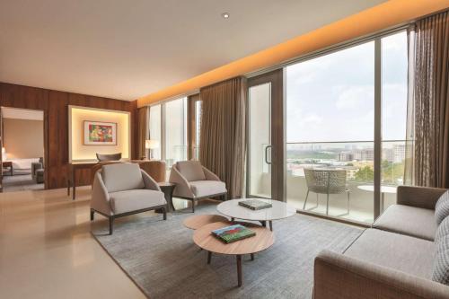 a living room with a couch and a table at Hilton Barra Rio de Janeiro in Rio de Janeiro