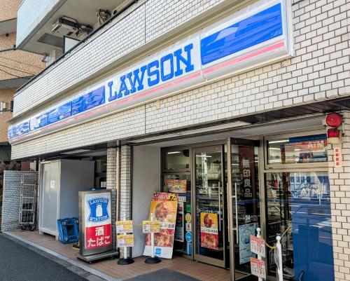 a grocery store with a sign on the front of it at Nomado Base at YOYOGI in Tokyo