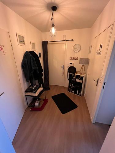 Cette chambre dispose d'un couloir avec une porte et une chaise. dans l'établissement Colocation Convivial, à Bruz