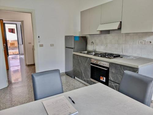 a kitchen with a table and two chairs and a stove at Venice Luxury Apartment in Venice