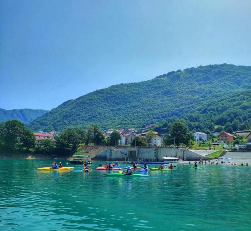 a group of people in kayaks on the water at Guest House Ethno Village Milogora in Pluzine