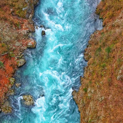 an aerial view of a river with blue water at Guest House Ethno Village Milogora in Pluzine