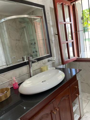 a bathroom with a white sink and a mirror at casa Salta in Salta