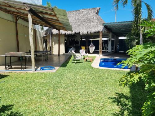 a backyard with a pool and a house at VIP Trailer Park and Bungalows. in Barra de Navidad