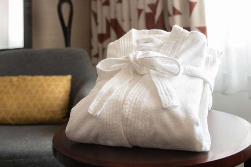 a white towel sitting on a table next to a couch at DoubleTree by Hilton San Francisco Airport in Burlingame