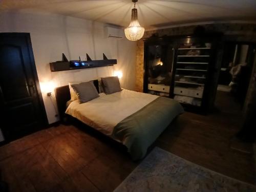 a bedroom with a large bed in a room at Manoir La Cerise in Fougerolles
