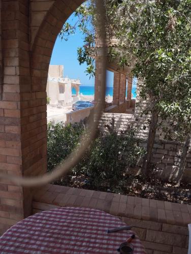 a view of the ocean through an archway at Chalet ElGammal in Marsa Matruh