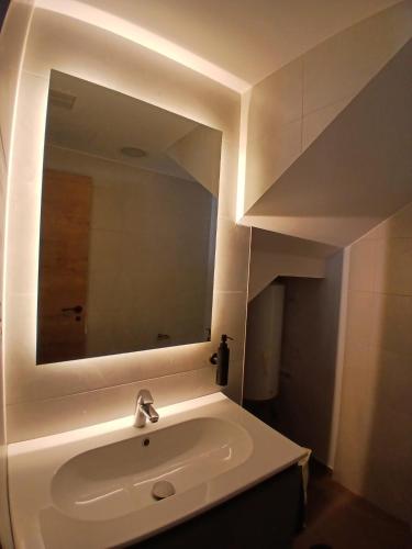 a bathroom with a sink and a mirror at Kalea Elysivm in Alcalá del Júcar