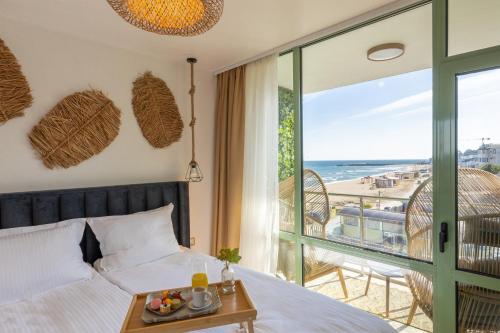 a bedroom with a bed and a view of the beach at Kabakum Avangard in Golden Sands