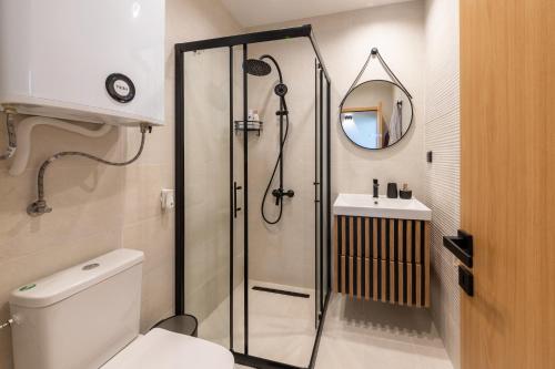 a bathroom with a shower and a toilet and a sink at Kabakum Avangard in Golden Sands