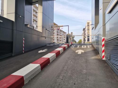 an empty street with red and white in a city at Royal apartman Banja Luka in Banja Luka