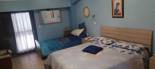 a bedroom with two beds and a mirror at Dietro Piazza Maggiore in Sulmona