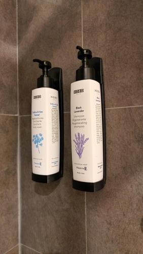 two bottles of hair products sitting on a wall at My home in Sarzana in Sarzana