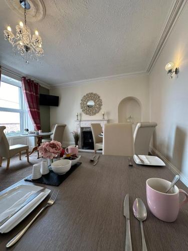 a living room with a table with utensils at Abbey House B & B in Penrith