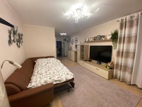 a living room with a couch and a flat screen tv at BS Business Travelling Hannover City in Hannover