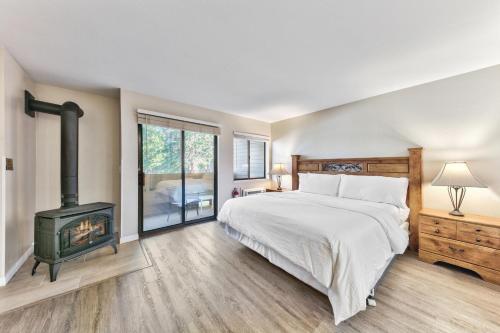 a bedroom with a bed and a wood stove at Lakeland Village 107 Laugh Love Updated Studio in South Lake Tahoe