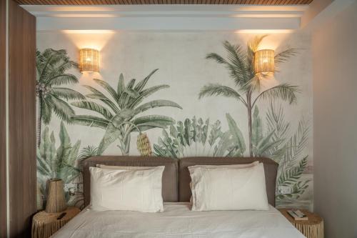 a bedroom with a mural of palm trees on the wall at ROP Penthouse & ROF Apartment by Homega, Terrace, Private Pool & Valletta Views in Sliema