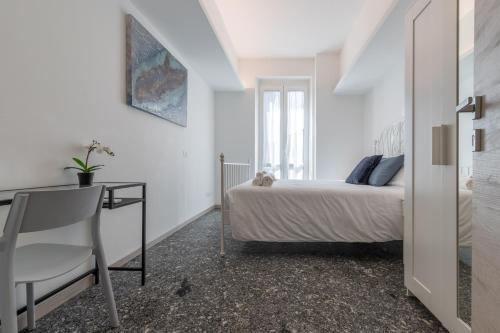 a bedroom with a bed and a desk and a chair at Santa Maria Gualtieri in Pavia