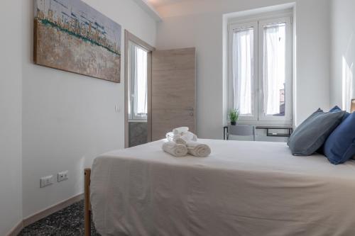 a bedroom with a large bed with towels on it at Santa Maria Gualtieri in Pavia