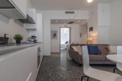 a kitchen and a living room with a couch at Santa Maria Gualtieri in Pavia