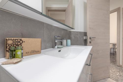 a bathroom with a white sink with a box on it at Santa Maria Gualtieri in Pavia