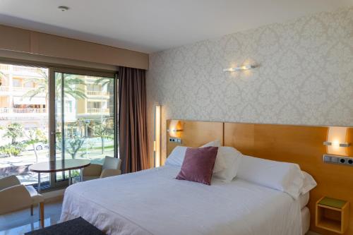 Postel nebo postele na pokoji v ubytování La Sort Boutique Hotel