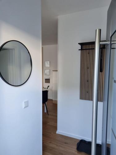 a mirror on a wall next to a hallway at Auszeit in der Vulkaneifel in Üdersdorf