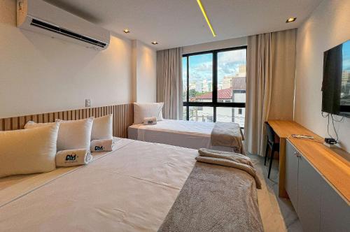 En eller flere senge i et værelse på Intermares Moderno Studio 3 pessoas 300m Praia