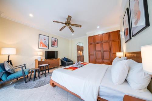 a bedroom with a large bed and a living room at View Talay Longstay in Jomtien Beach