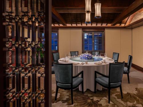 a dining room with a table and chairs at Waldorf Astoria Shanghai on the Bund in Shanghai