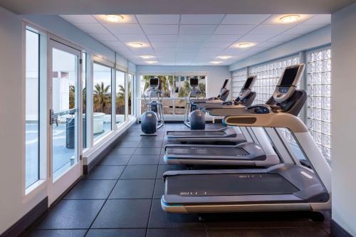 a row of treadmills in a gym with windows at Hilton San Jose in San Jose