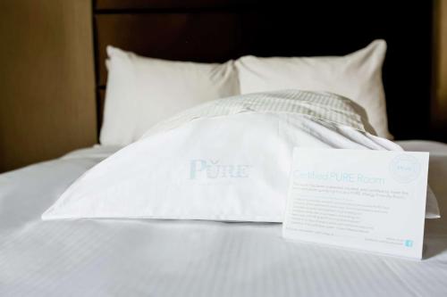 a white pillow with a box on top of a bed at Hilton Salt Lake City Center in Salt Lake City