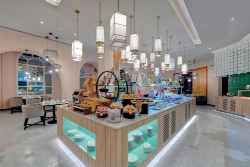 a store with chandeliers and a counter with food at Hilton Salalah Resort in Salalah