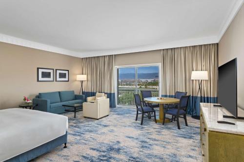 a hotel room with a bed and a living room at Hilton Salalah Resort in Salalah