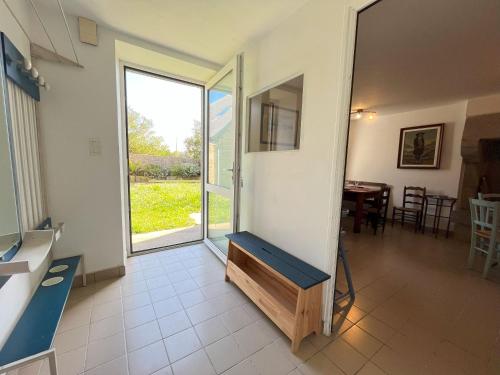a living room with a large sliding glass door at Maison double en pierres pour grande famille ou groupe amis in Sibiril