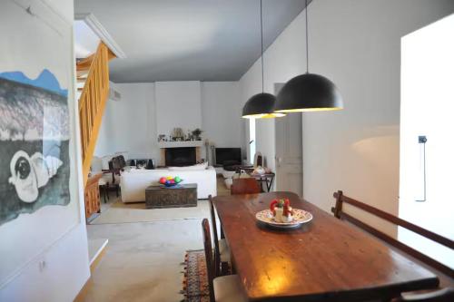 a dining room with a table and a bedroom at Zeus House by GHH in Hydra