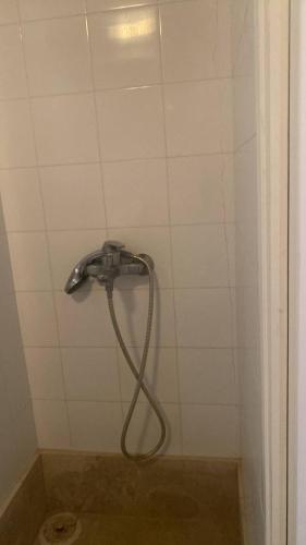 a shower with a hose in a bathroom at Zeus House by GHH in Hydra