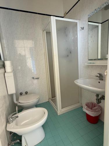 a bathroom with a toilet and a sink and a shower at Rooms Casa Celeste sul Mare in Cesenatico