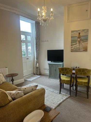 a living room with a couch and a table at Lovely 1 bed flat in Victorian house 300m seafront in Penzance