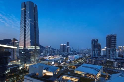 a city skyline at night with tall buildings at Hilton Shenzhen Shekou Nanhai in Shenzhen