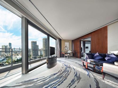 a living room with a view of a city at Hilton Shenzhen Shekou Nanhai in Shenzhen
