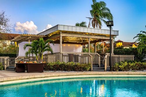 a house with a swimming pool in front of a building at Hilton Tampa Airport Westshore in Tampa