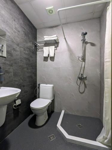 a bathroom with a toilet and a sink at Hotel La Roka in Stara Zagora