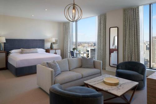 a hotel room with a bed and a couch at Hilton Toronto in Toronto