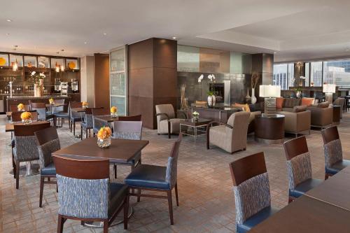 a restaurant with tables and chairs and a lobby at Hilton Toronto in Toronto