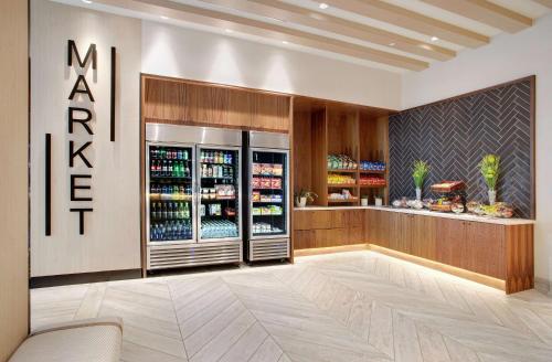 a kitchen with a refrigerator with drinks in it at Embassy Suites by Hilton Tampa Downtown Convention Center in Tampa