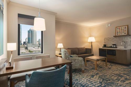 a living room with a table and a couch at Embassy Suites by Hilton Tampa Downtown Convention Center in Tampa