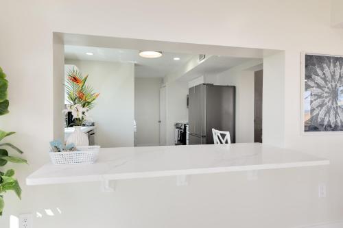 a kitchen with a white counter and a mirror at Be a Nomad - Ocean Front Boutique Hotel in Jacksonville Beach